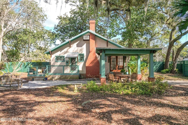 rear view of property with french doors and a patio area