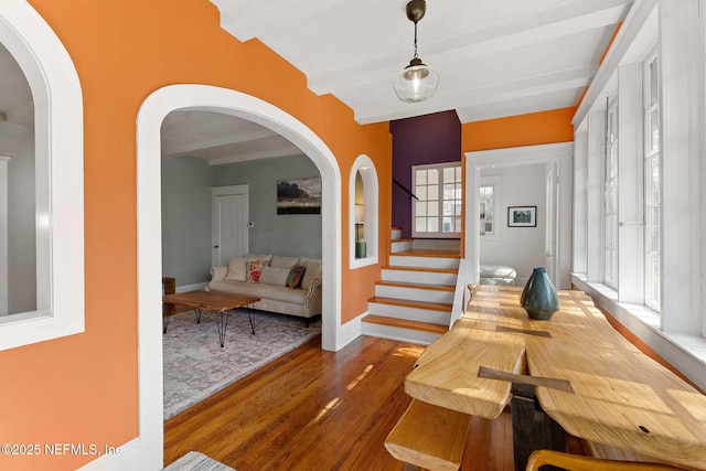 dining area featuring beamed ceiling and dark hardwood / wood-style floors