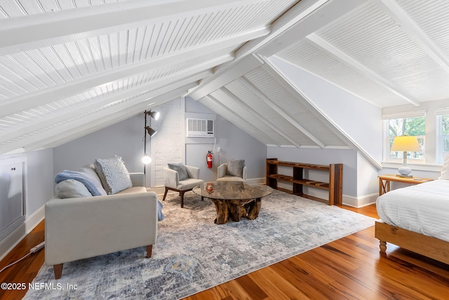 bedroom featuring hardwood / wood-style floors, a wall mounted air conditioner, and lofted ceiling with beams