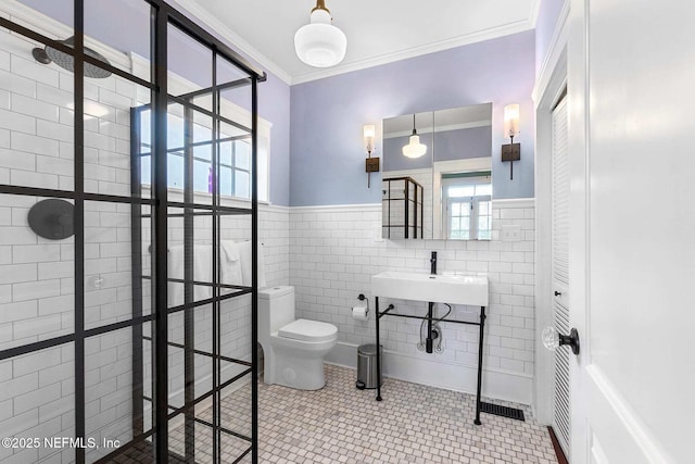 bathroom with crown molding, a healthy amount of sunlight, tile patterned floors, and sink