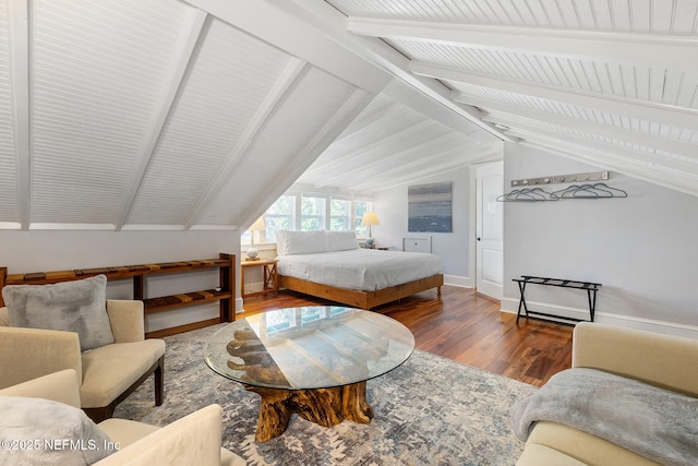 bedroom featuring wood-type flooring and lofted ceiling with beams