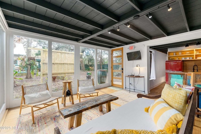 sunroom featuring beamed ceiling, sink, track lighting, and wood ceiling