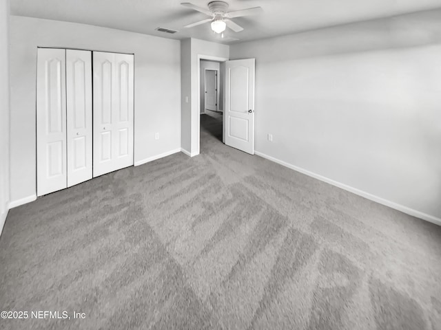 unfurnished bedroom with carpet floors, a closet, and ceiling fan