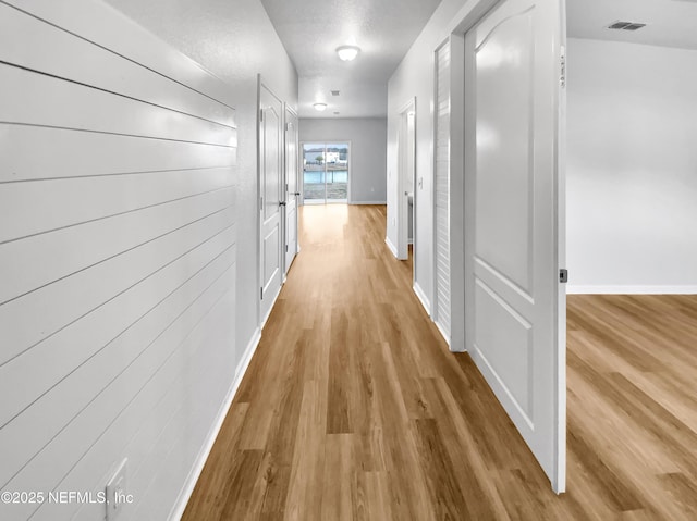 corridor featuring wood-type flooring