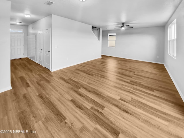 unfurnished living room featuring hardwood / wood-style flooring and ceiling fan