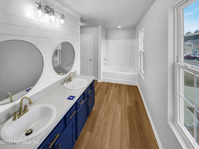 bathroom with vanity, bathtub / shower combination, and hardwood / wood-style floors