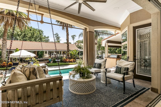 sunroom featuring ceiling fan and vaulted ceiling