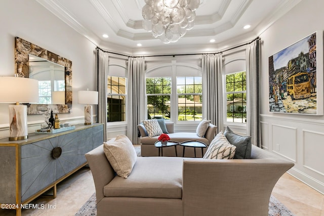 living area featuring crown molding and an inviting chandelier