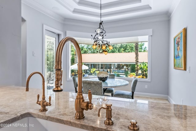 dining room featuring crown molding and a raised ceiling