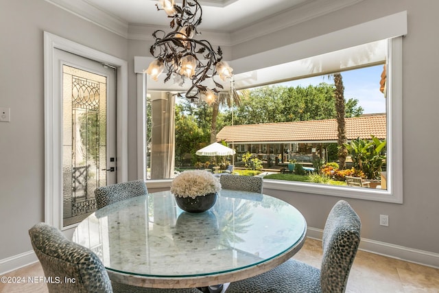 dining space featuring an inviting chandelier and ornamental molding