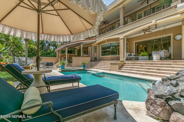 view of pool with ceiling fan and a patio area