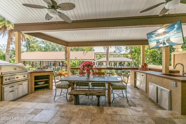 view of patio / terrace featuring an outdoor kitchen, grilling area, ceiling fan, and sink