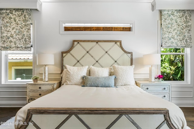 bedroom featuring dark wood-type flooring and ornamental molding