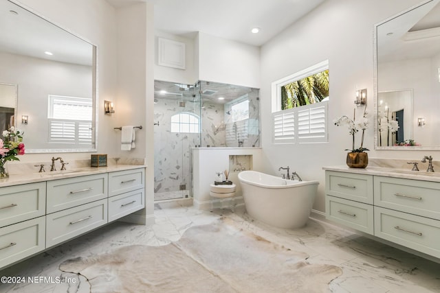 bathroom featuring vanity, plenty of natural light, and separate shower and tub