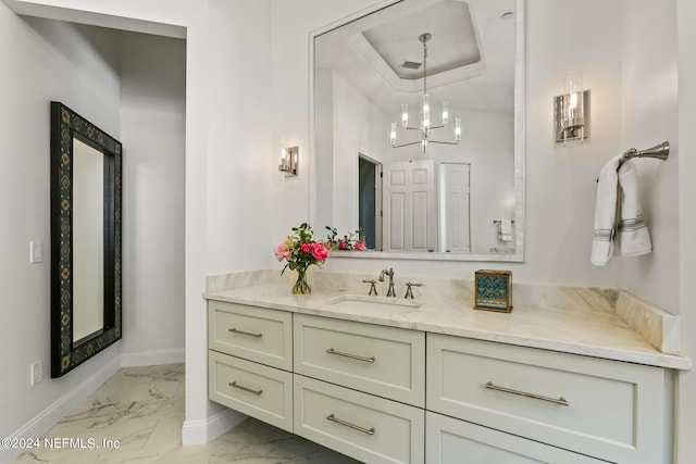 bathroom with vanity and a chandelier