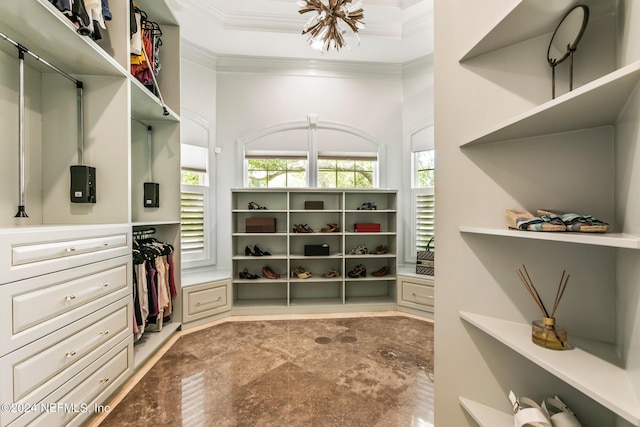 walk in closet featuring an inviting chandelier