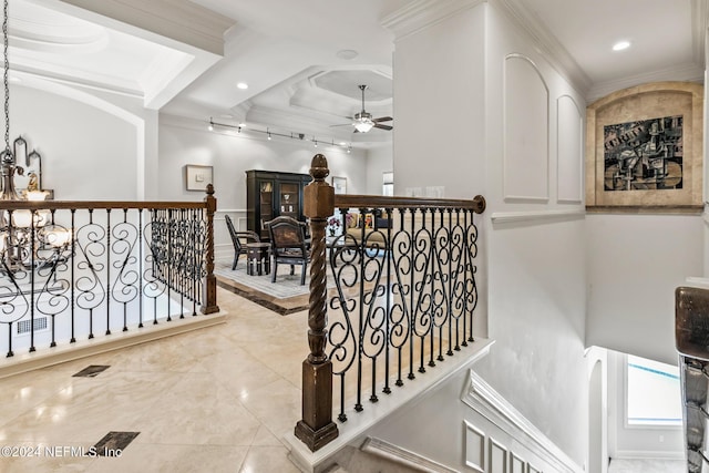 hall with an inviting chandelier and ornamental molding