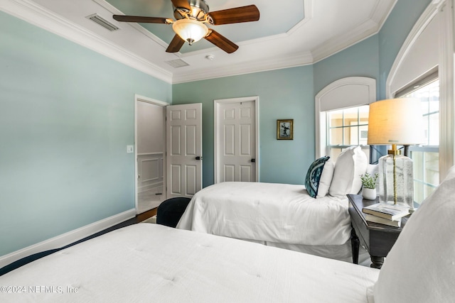 bedroom featuring hardwood / wood-style floors, crown molding, and ceiling fan