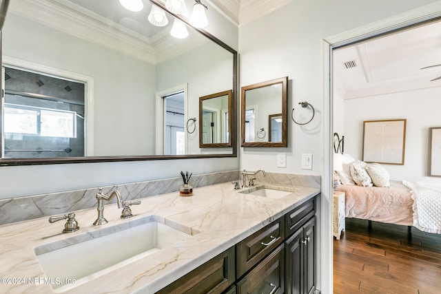 bathroom with crown molding, vanity, and hardwood / wood-style floors