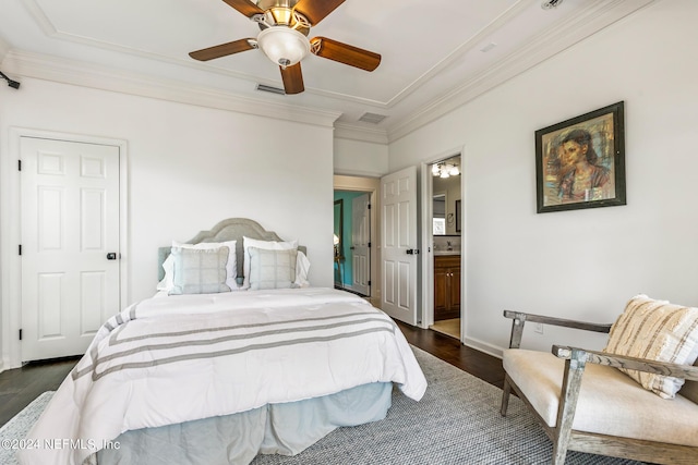 bedroom featuring ornamental molding, dark hardwood / wood-style floors, ceiling fan, and ensuite bath