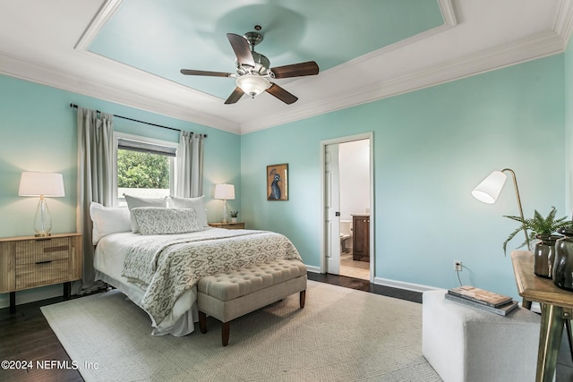 bedroom with crown molding, dark hardwood / wood-style floors, ensuite bathroom, and ceiling fan