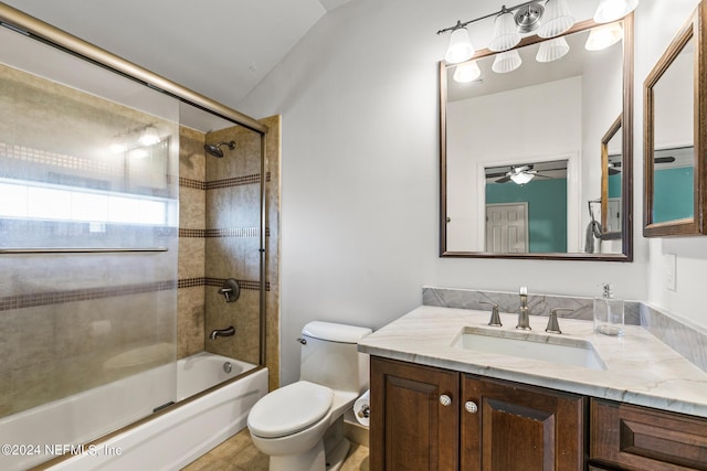 full bathroom featuring enclosed tub / shower combo, vanity, and toilet