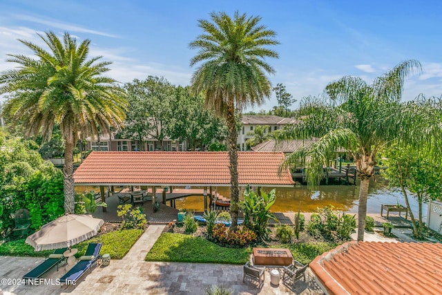 surrounding community featuring a dock and a water view