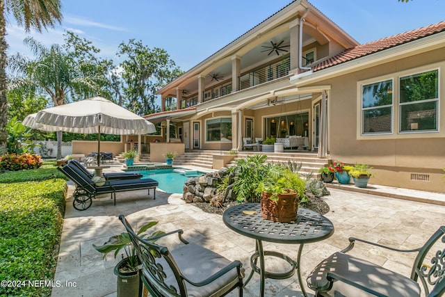 back of house with a fenced in pool, a patio, a balcony, and ceiling fan