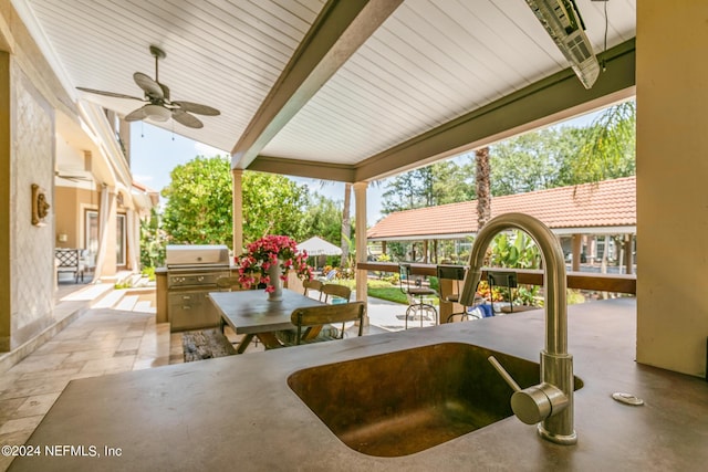 view of patio / terrace featuring ceiling fan, grilling area, exterior kitchen, and sink