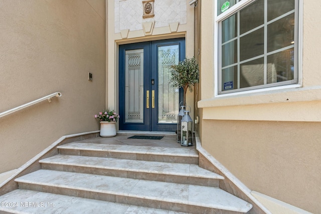 property entrance featuring french doors