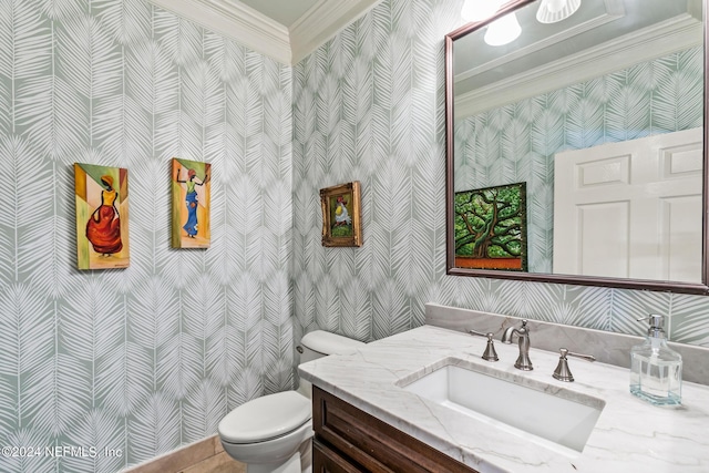 bathroom with crown molding, vanity, and toilet