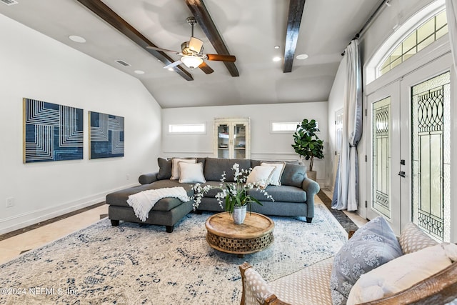 living room featuring french doors, ceiling fan, a healthy amount of sunlight, and vaulted ceiling with beams