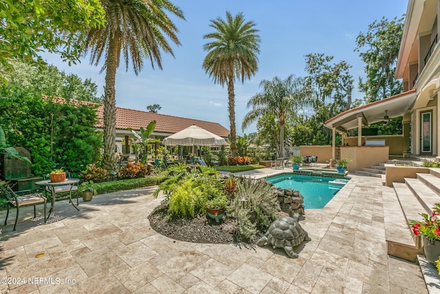 view of pool featuring a hot tub and a patio