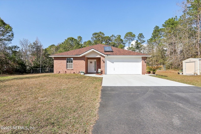 ranch-style home featuring a garage, a front lawn, and solar panels