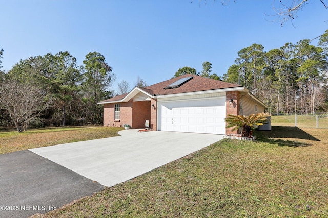 single story home featuring a garage, a front yard, and solar panels