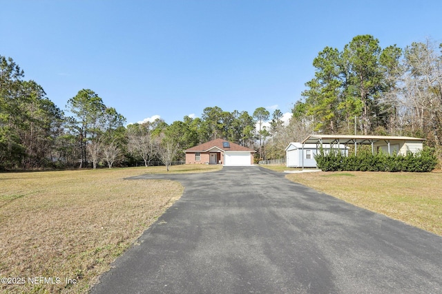 view of front of house featuring a garage and a front lawn