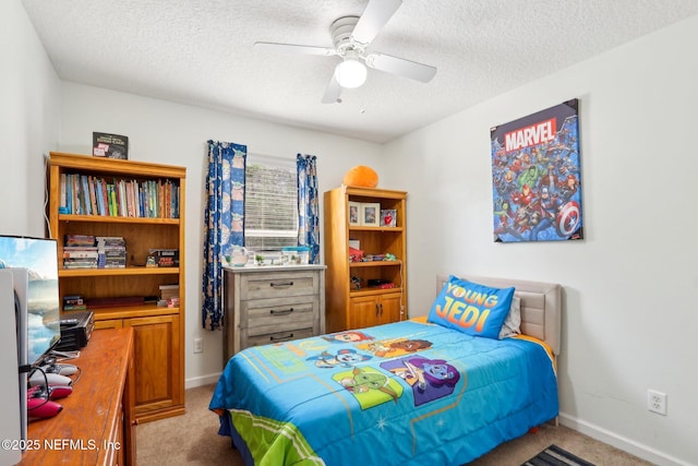 carpeted bedroom featuring ceiling fan and a textured ceiling