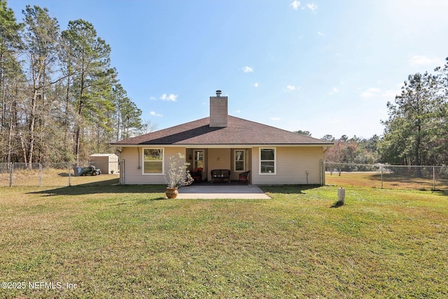 back of house featuring a yard and a patio area