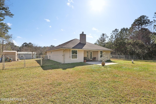 rear view of house with a lawn and a patio area