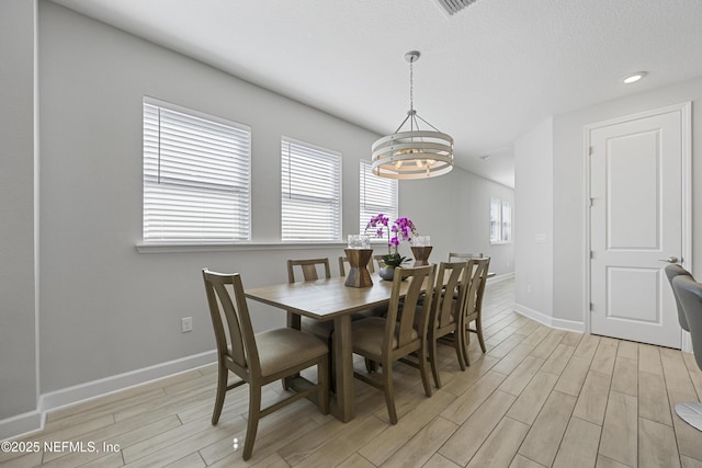 dining room featuring a notable chandelier and a textured ceiling