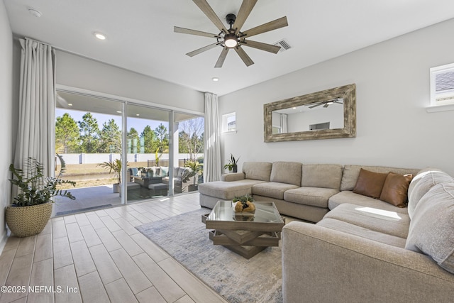 living room with ceiling fan and light wood-type flooring