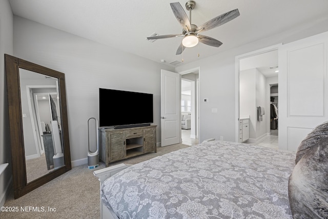 carpeted bedroom with ceiling fan and ensuite bathroom