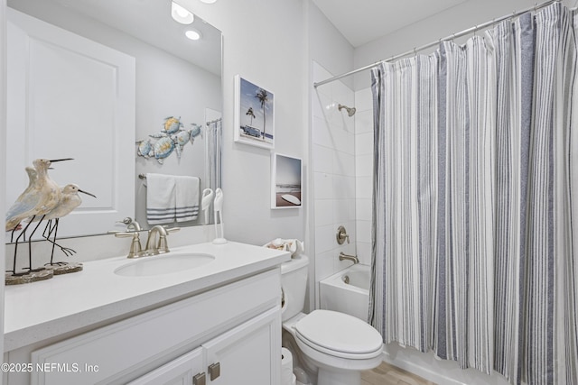 full bathroom with shower / bathtub combination with curtain, vanity, and toilet