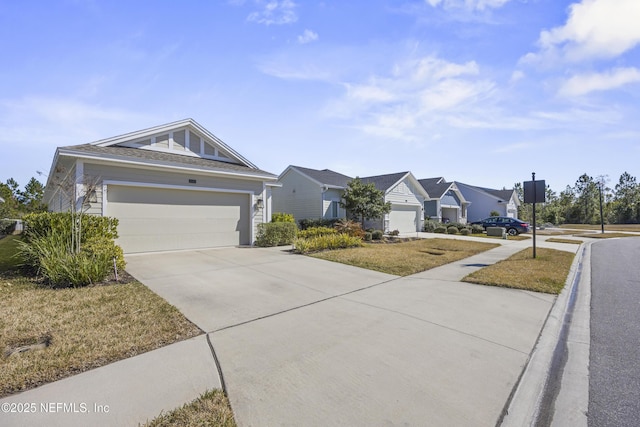 view of front of house featuring a garage and a front lawn