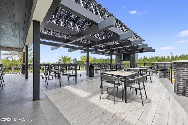 wooden deck featuring a pergola and a patio