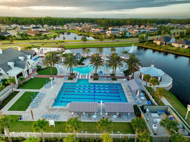 drone / aerial view featuring a residential view and a water view