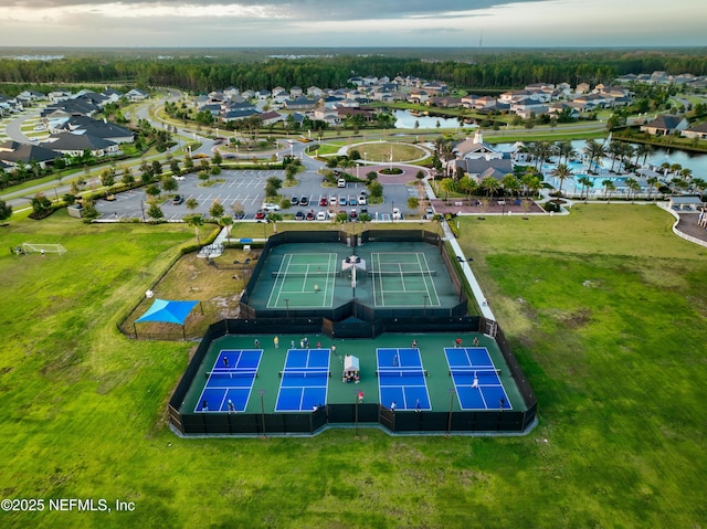 drone / aerial view featuring a water view and a residential view