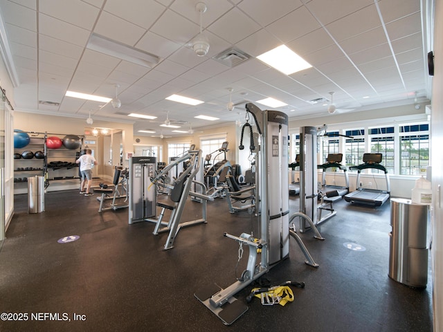 workout area with crown molding, a paneled ceiling, and visible vents