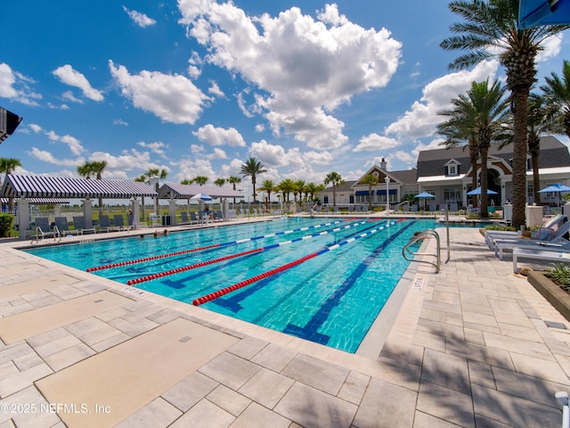 pool featuring a patio area, a residential view, and fence