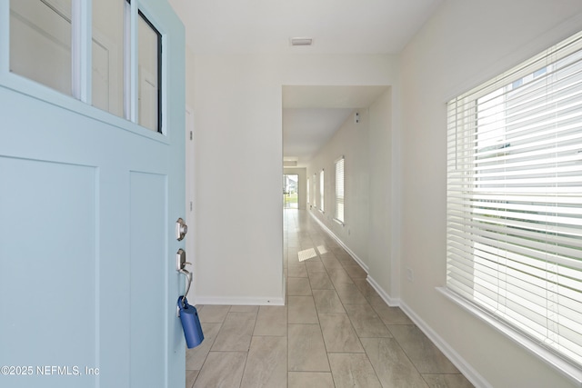 hall featuring baseboards